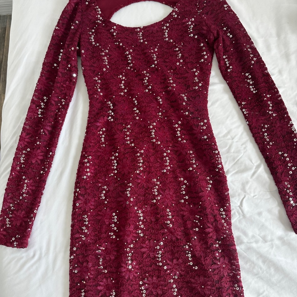 Red sequin midength dress and black shirt floral sleeves